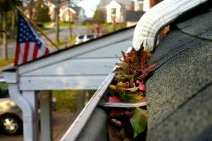 bigstock-Fall-Cleanup-Leaves-In-Gutte-2561077-300x200