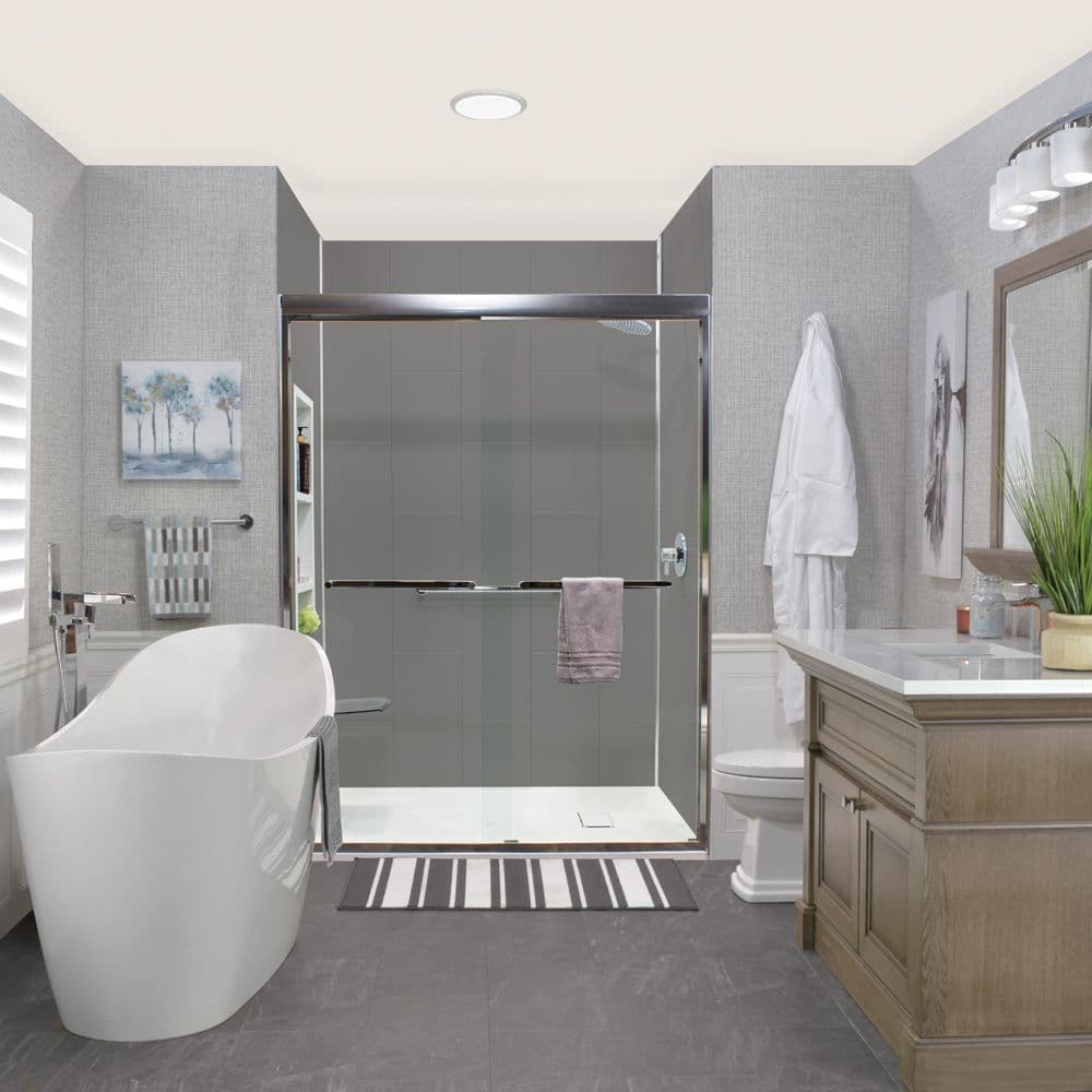 Modern bathroom with freestanding soaking tub, walk-in shower with glass enclosure, wooden vanity, and gray tile flooring